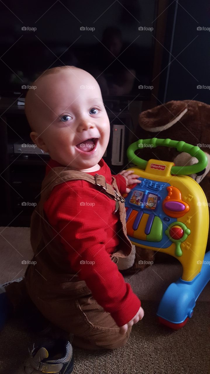 Cute baby boy playing with toy