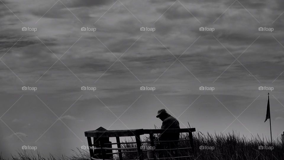 man sits alone on the beach