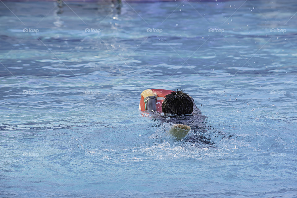 Asean boys are swimming in the pool.