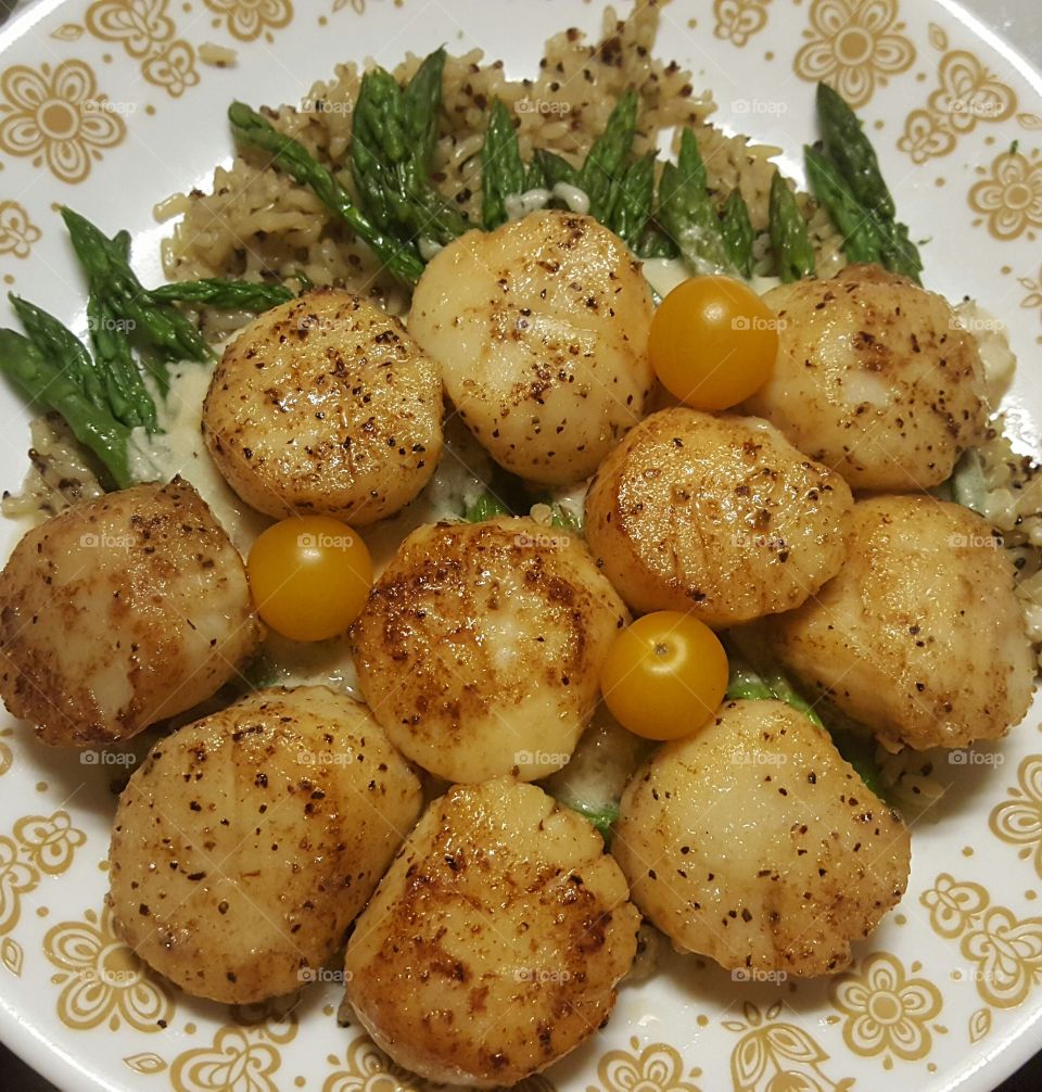 Scallops with white wine an butter sauce reduced and kissed with cream, served over quinoa and seasonal veggies.