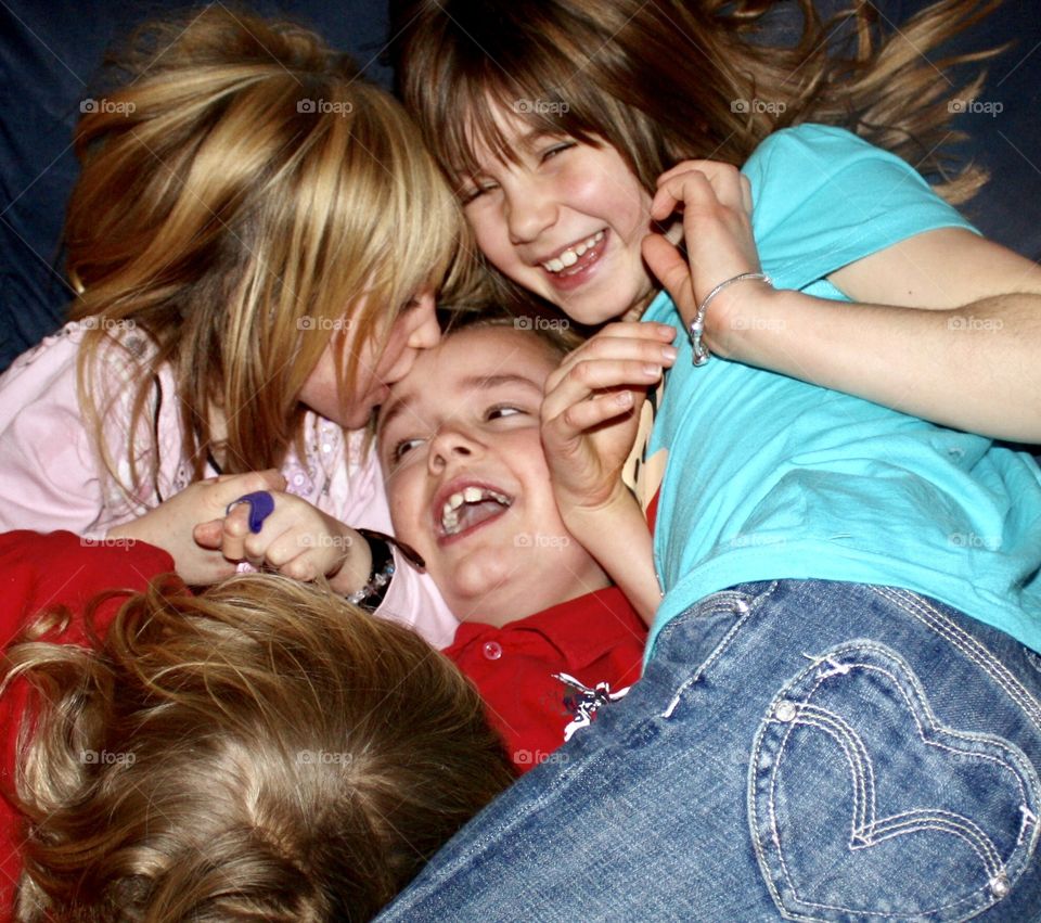 Cousins showing their love with laughter and kisses