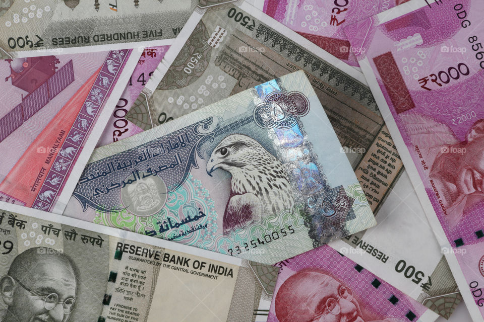 Uae dirham currency note between Indian new currency bank notes