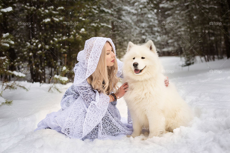 Woman sitting with dog in winter