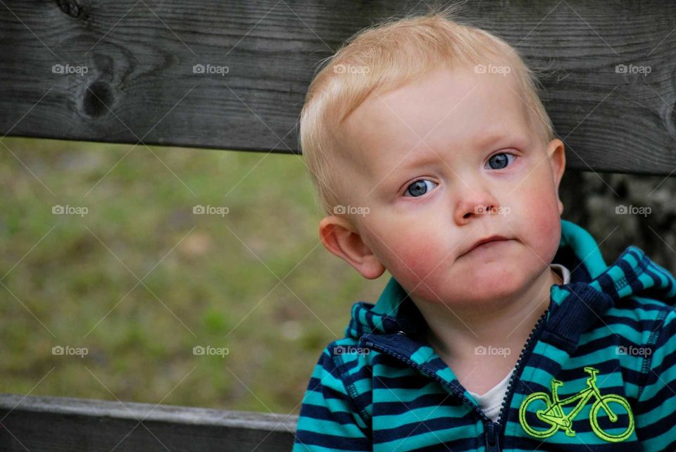 Child against wooden fence