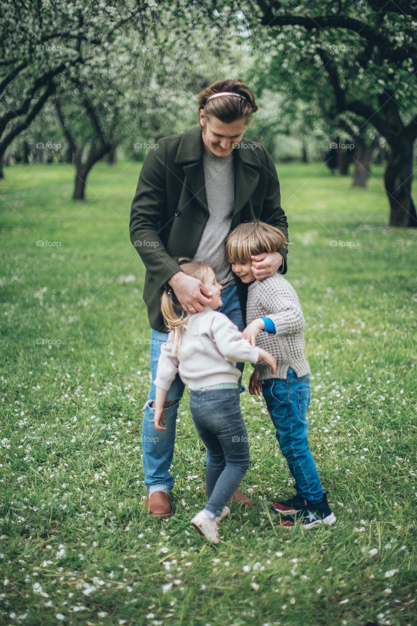Kids welcoming dad from work,they are happy to see daddy at home again