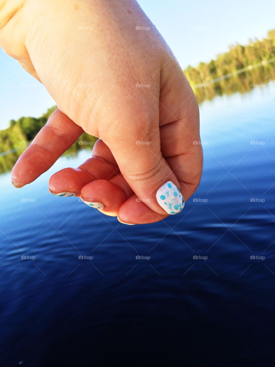 Hand. Hand over water