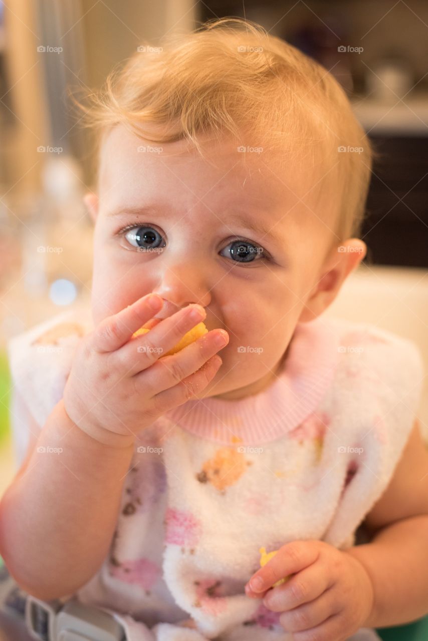 Close up of baby in bib eating. 