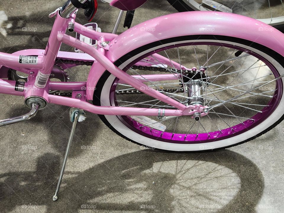 close up view of Barbie style shiny pink bicycle for sale in an Oregon sporting goods store