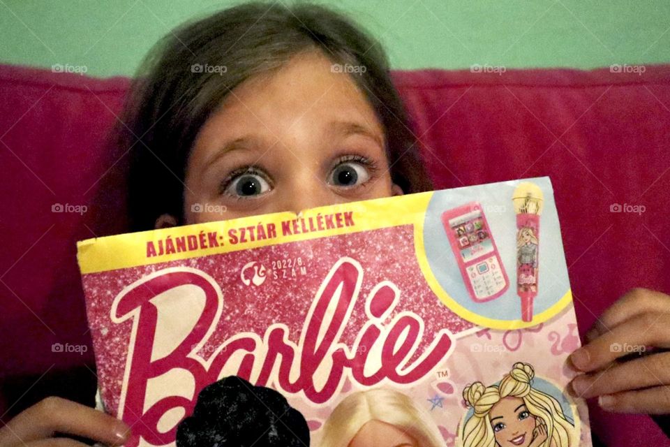 Girl reading her Barbie magazine 