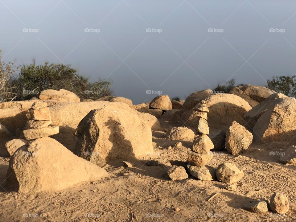 rock balancing/cairns/stacks at the top of a mountain on an early morning hike