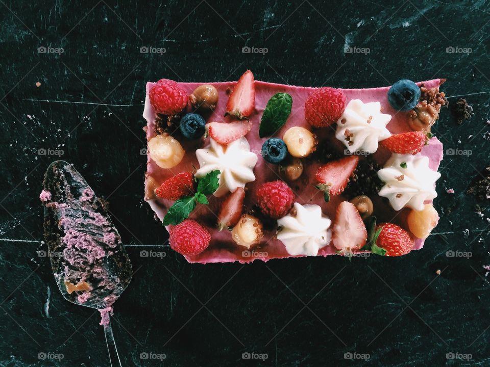 Fruit and berries on a raspberry mousse cake