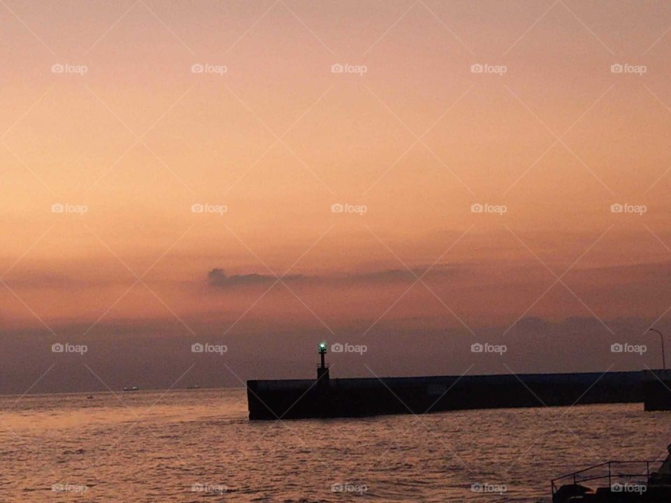 lighthouse of outlying island at dawn.