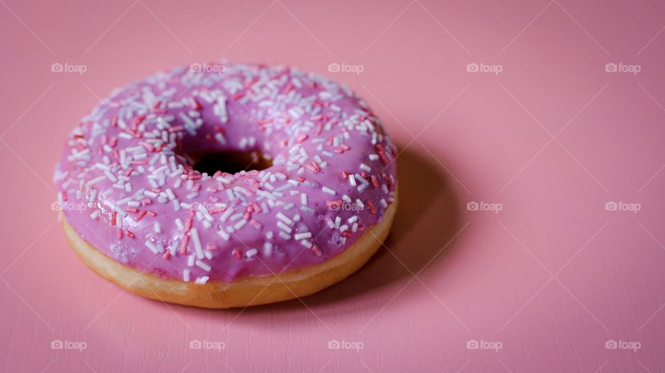 Pink donut on the pink background 