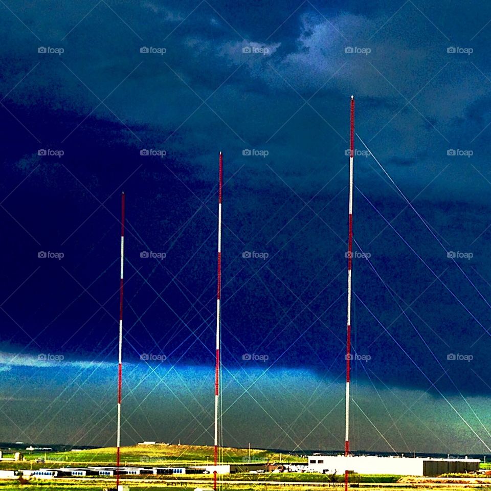 Tri-towers. Towers in front of an oncoming storm