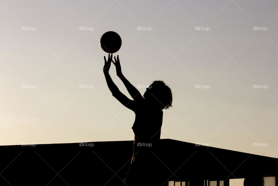 Silhouette of a woman and ball