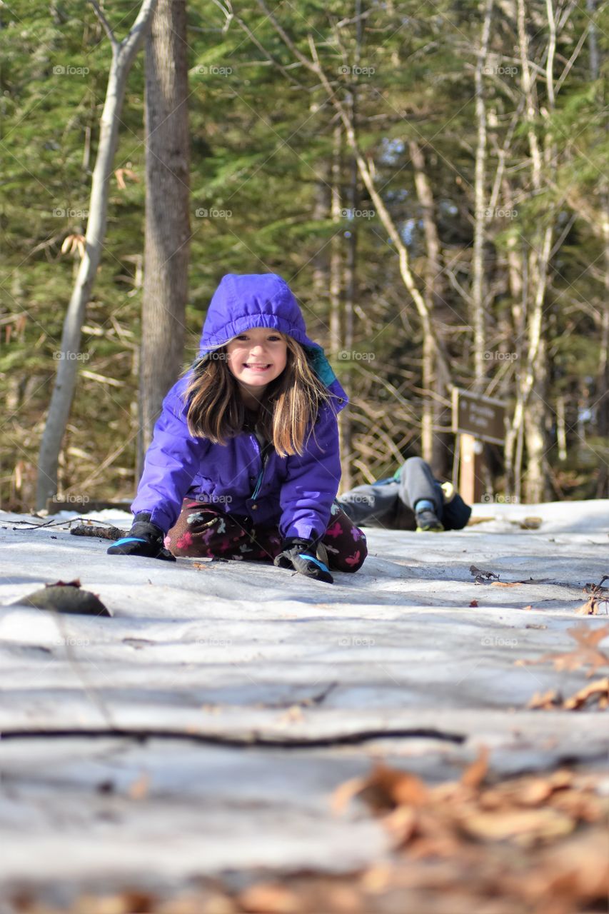 girl sledding on ice