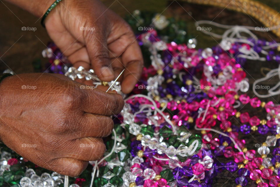 Close-up of a woman making bracelet