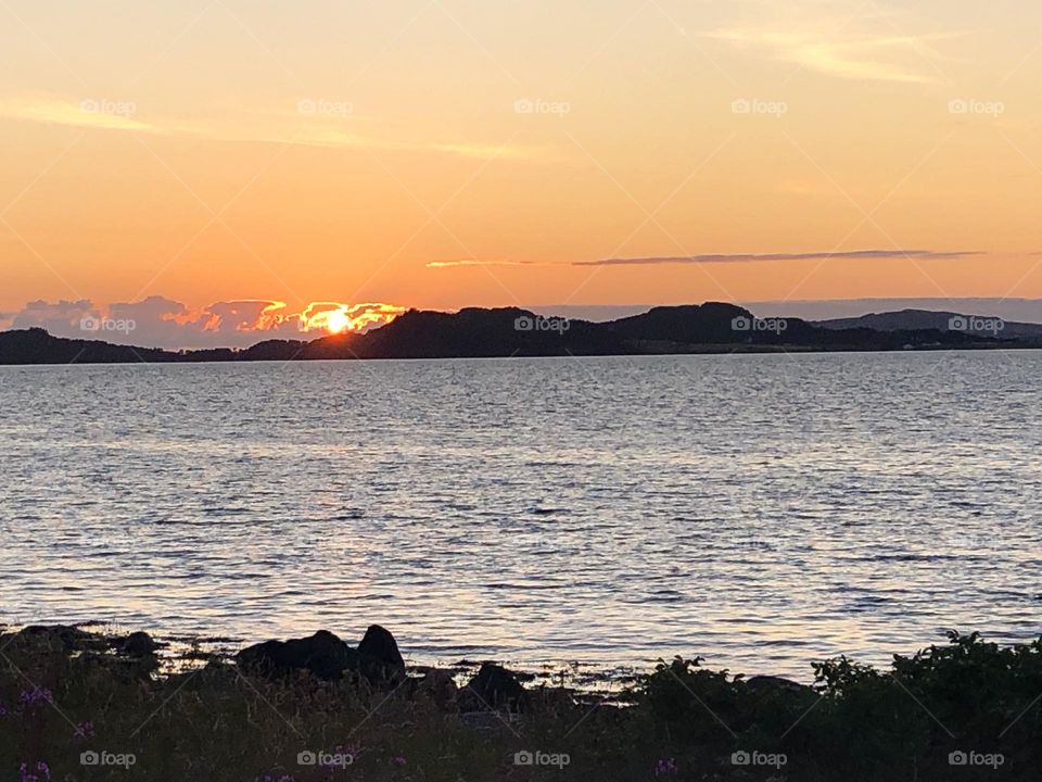 Sunset over mountains and lake