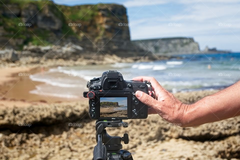 Taking photos with a camera on the tripod 