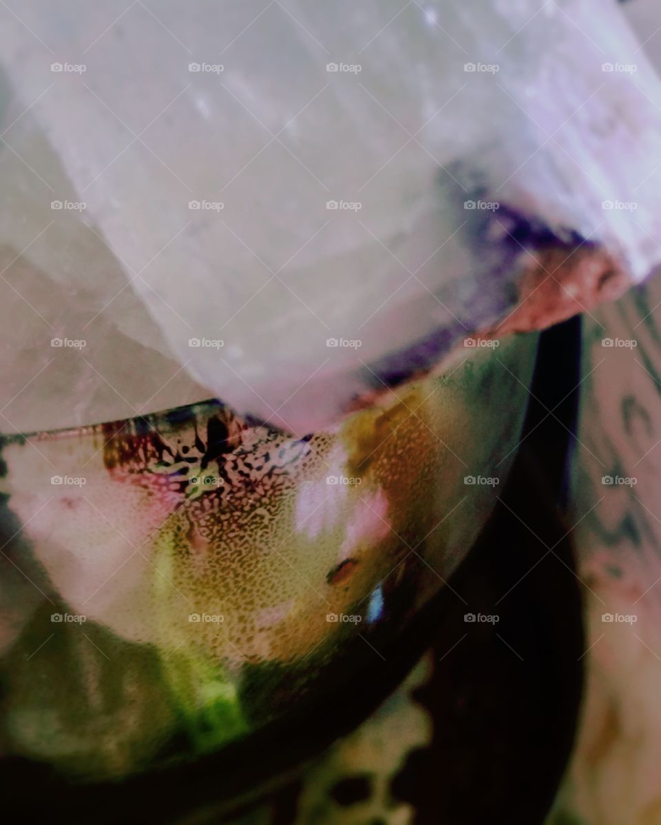 Crystal in a jar. The jar was something I used to muffle incent smoke and it has a nice little pattern. Next to it is a bone carving.