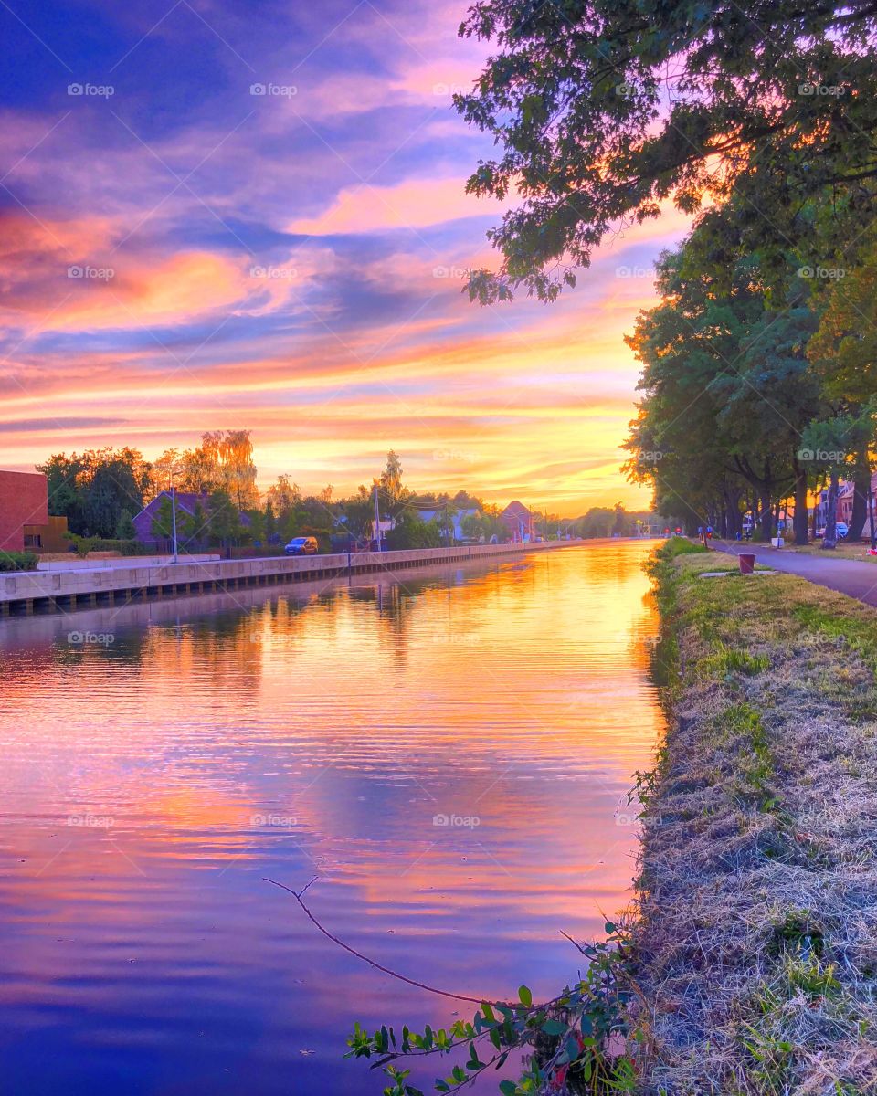 Colorful and idyllic sunset reflected in the water 