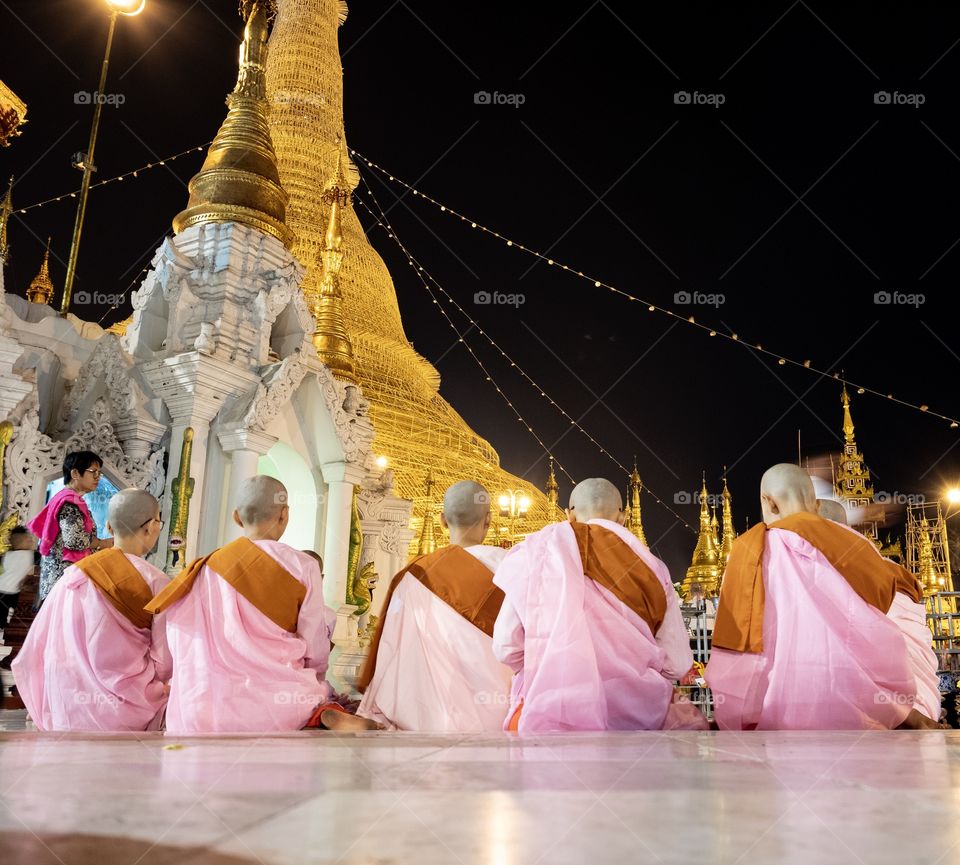 Nuns’ er sitting to pray at Shwedagon pagoda , Myanmar