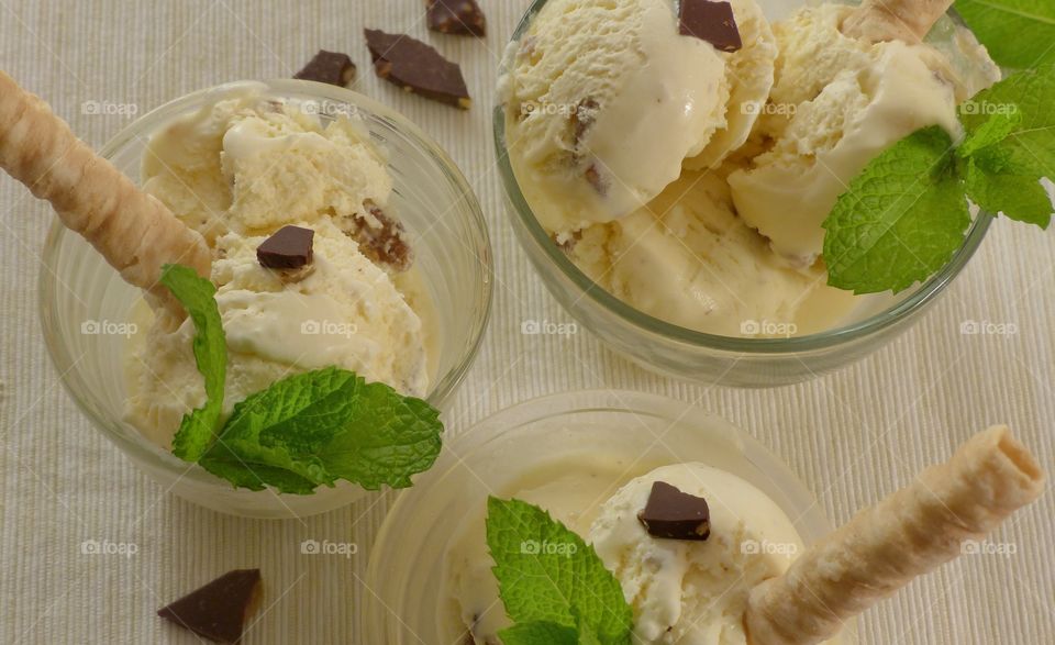 Bowl of vanilla ice creams with mint leaf