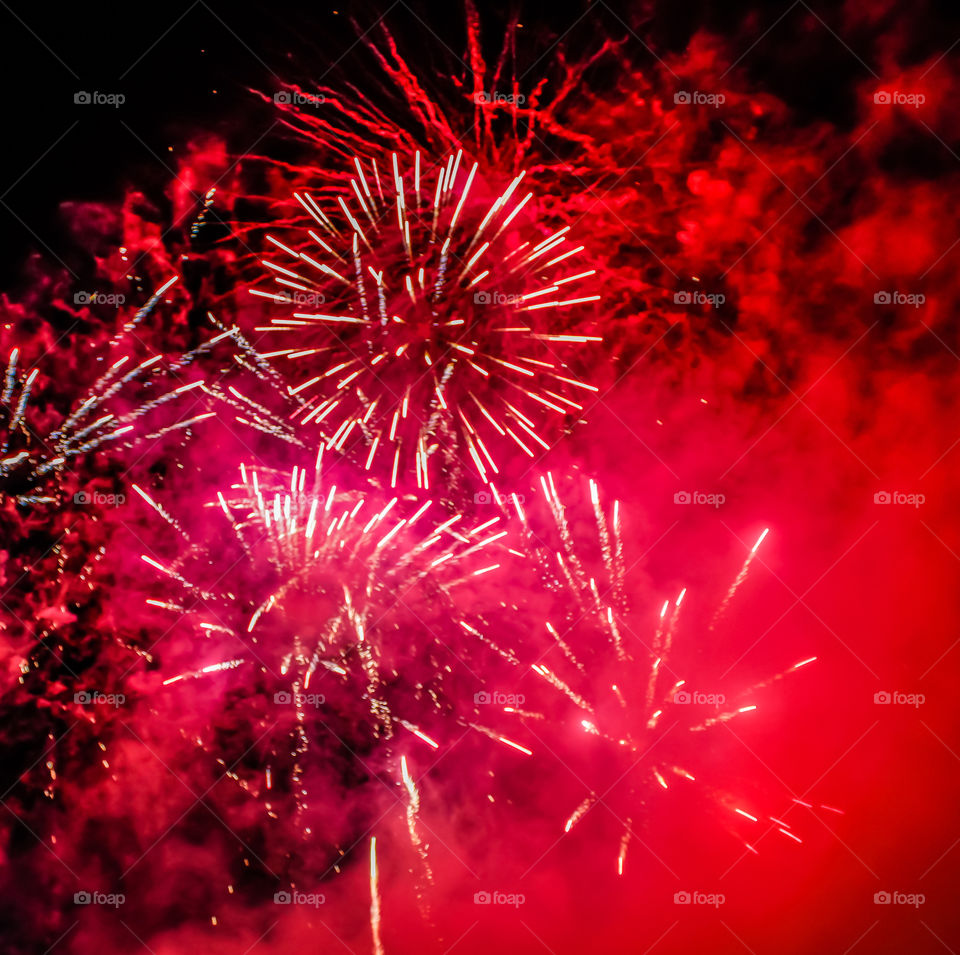 Red fireworks, the dark sky is also filled with red smoke and trails of fireworks