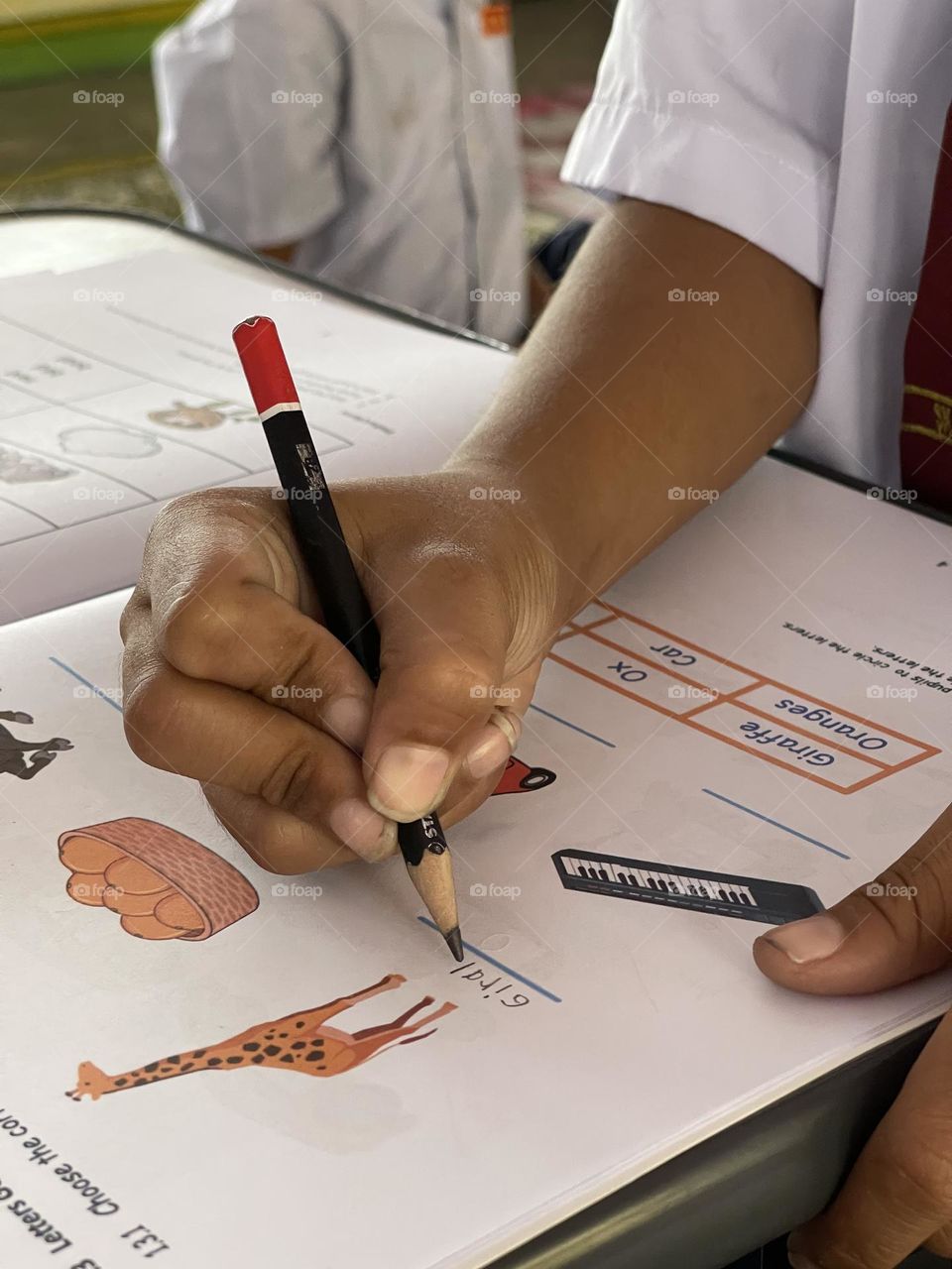 Natural look of a poor boy nails while writing in class