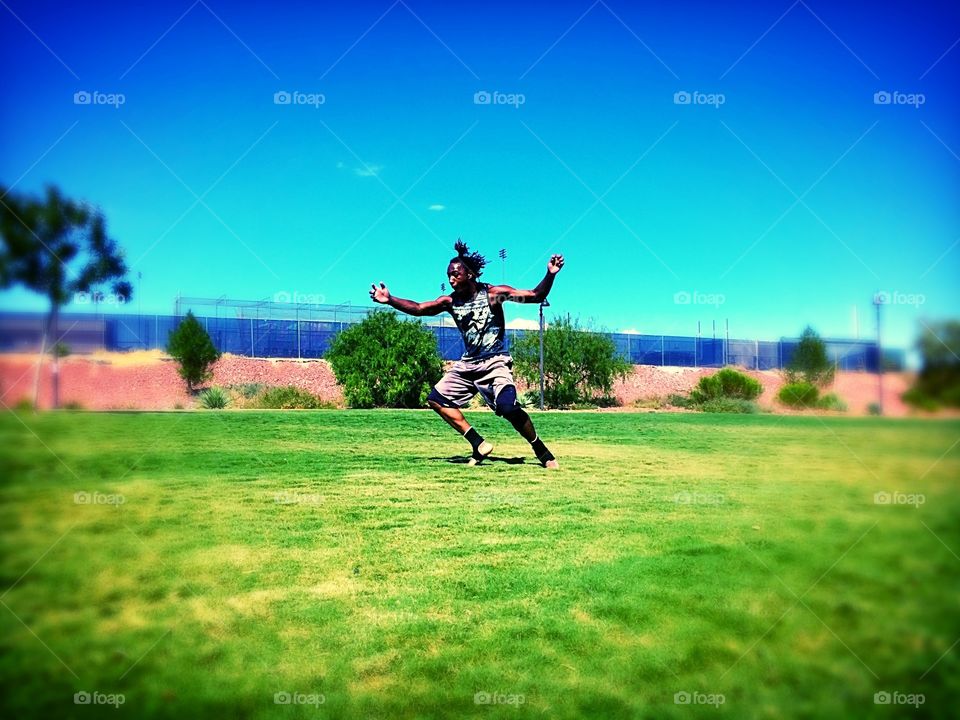 Park action shots. Kid in the park practicing his flips 