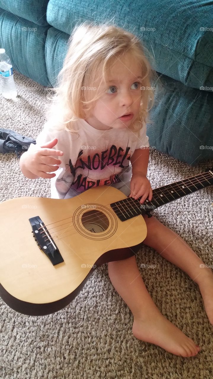 My daughter playing with the guitar