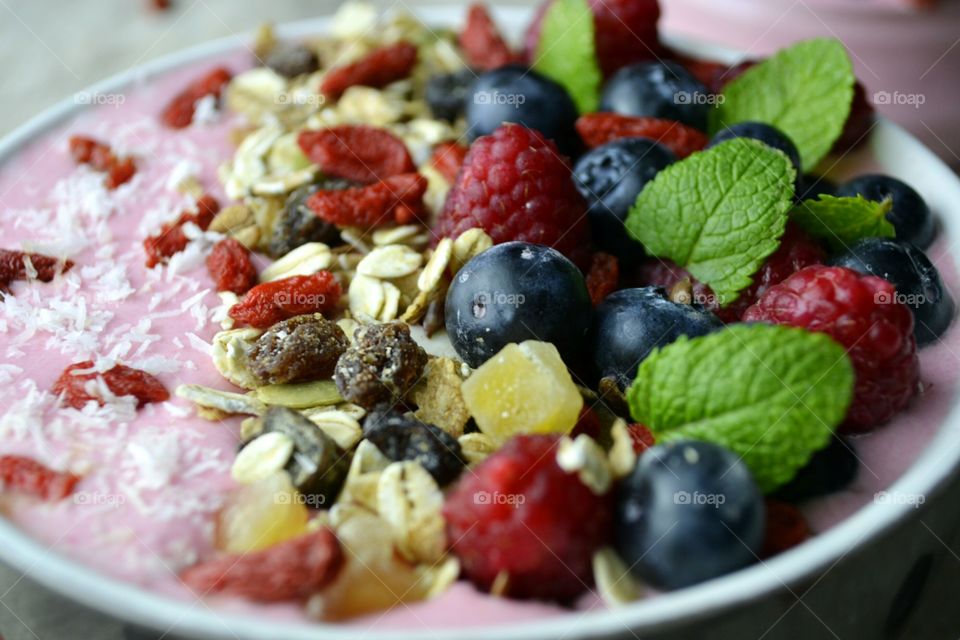 Fruit Smoothie in bowl with raspberries and blueberries