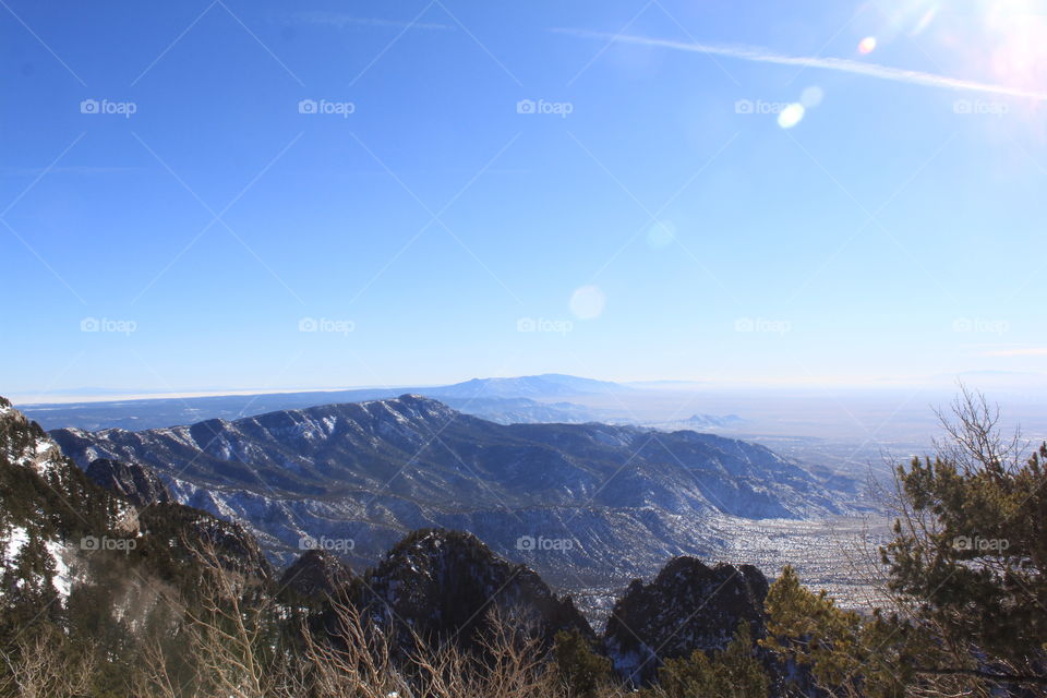 Sunlight over mountain during winter