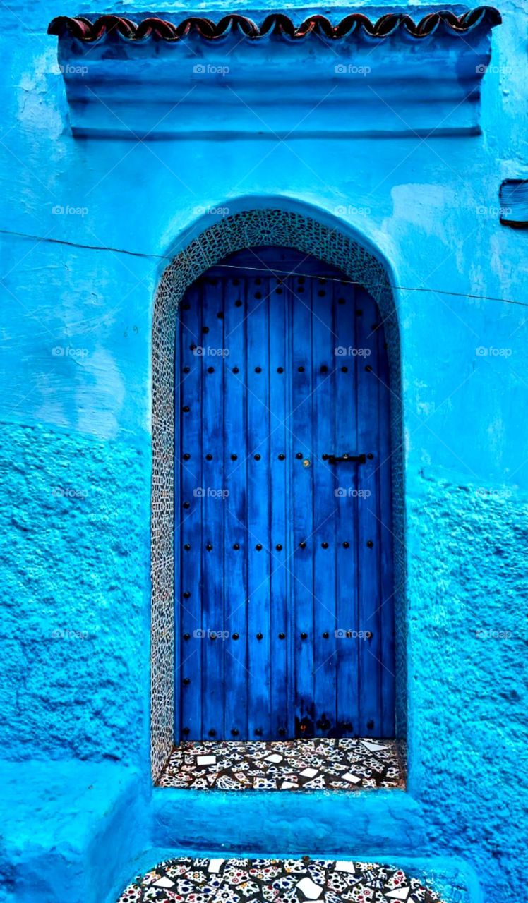 Main small door it's a nice blue door and wall paint a nice colour stone steps