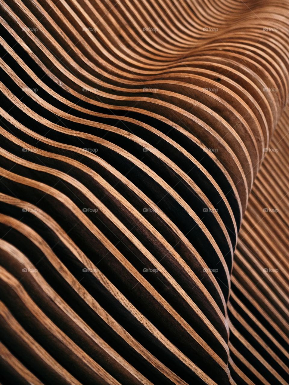 Close-up detail of wood slats creating a flowing pattern