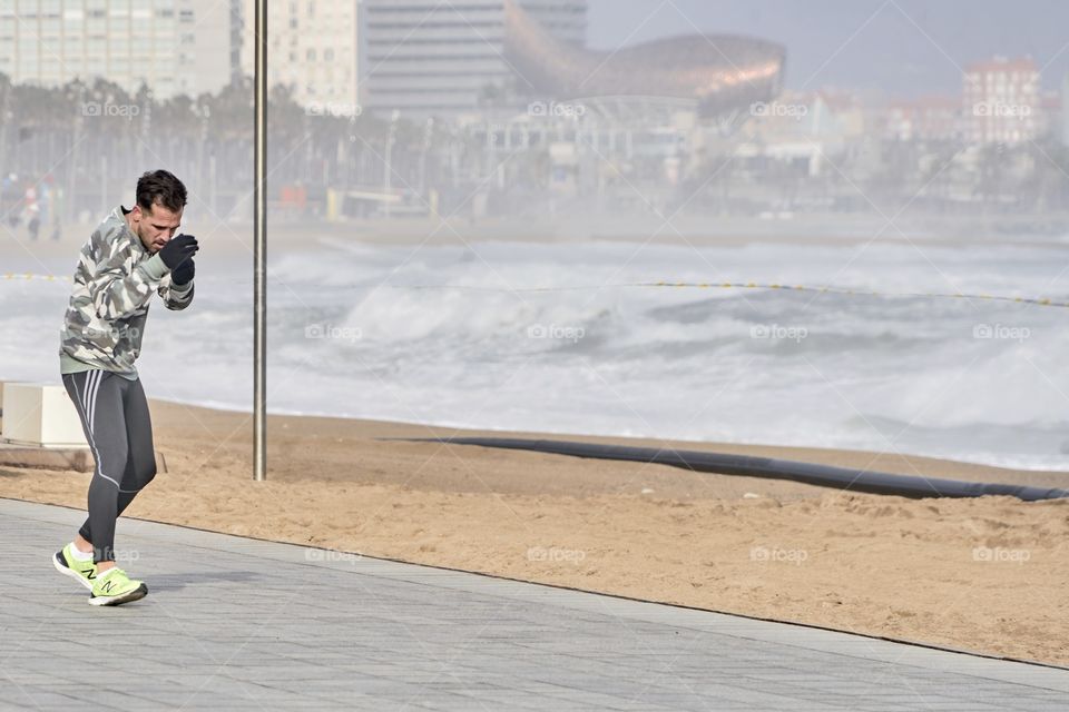 Practicing Boxing by the sea in a cold and grey day
