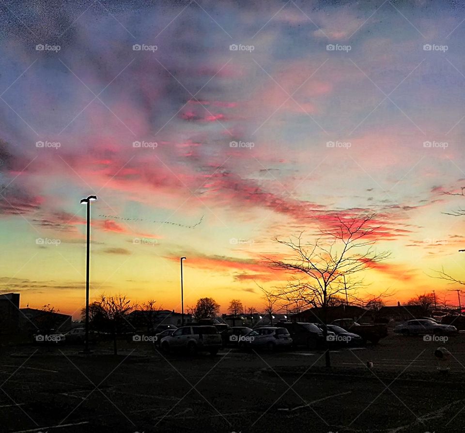 sunset above shopping center parking lot