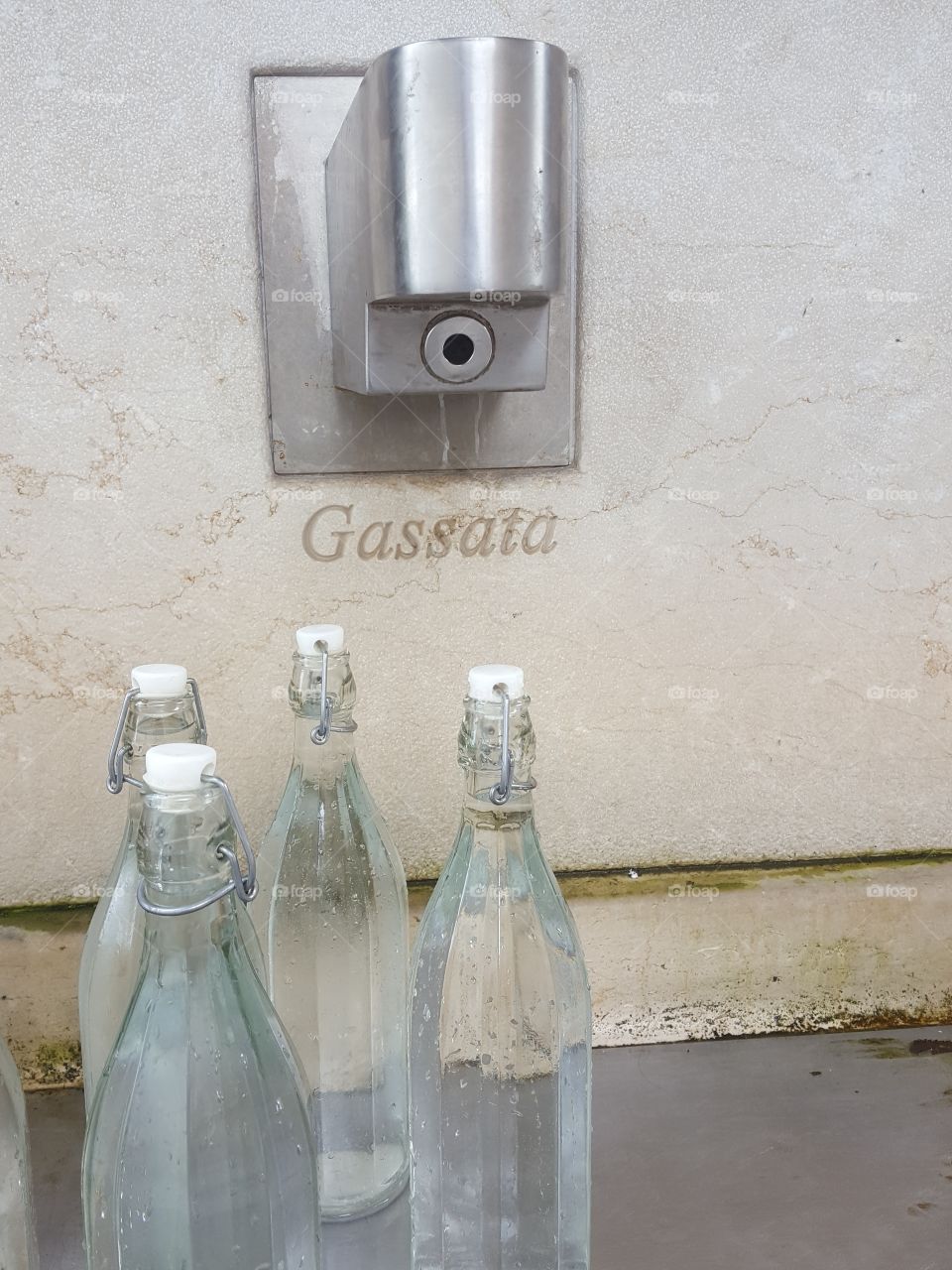Full drinking water bottles, at the municipal distributor. Gased and natural, clear pure and controlled.