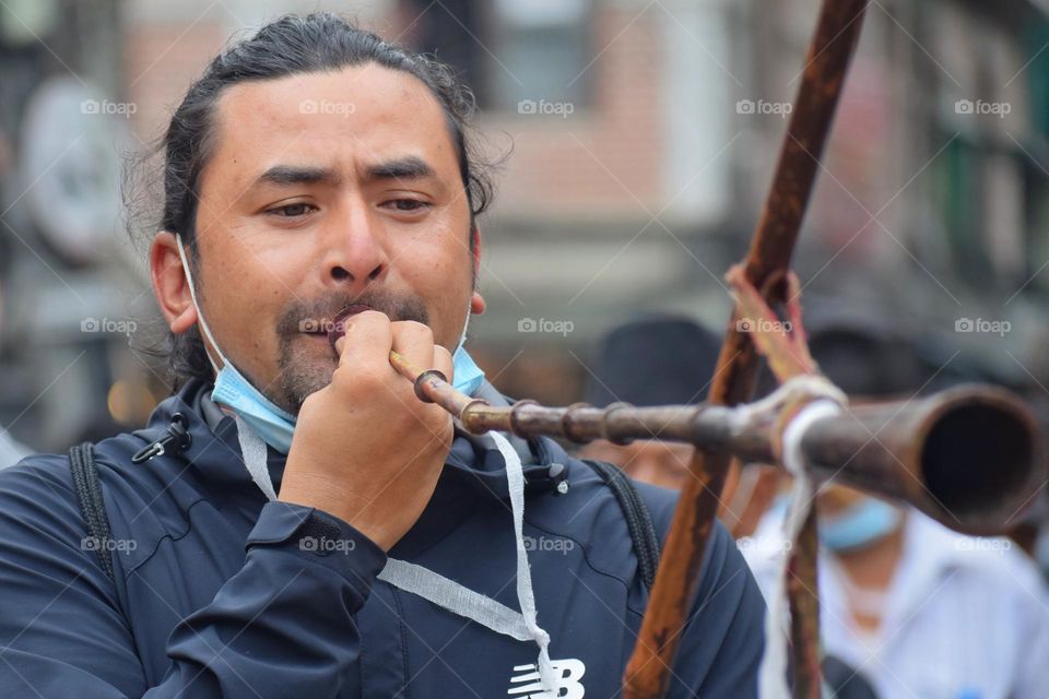 The music man; man playing music during hindu festival indrajatra at kathmandu, Nepal