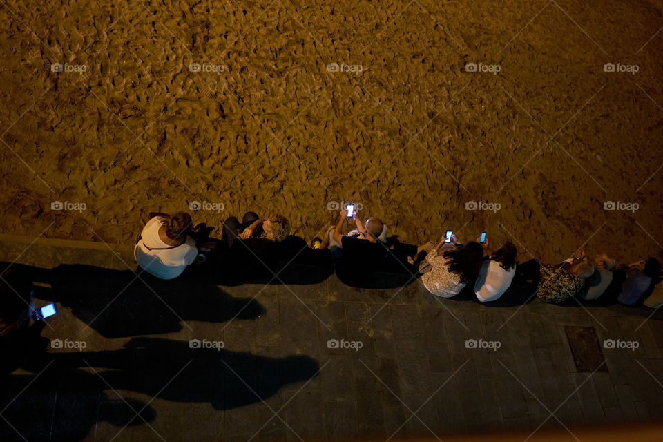 Phone communication in a summer night at the beach