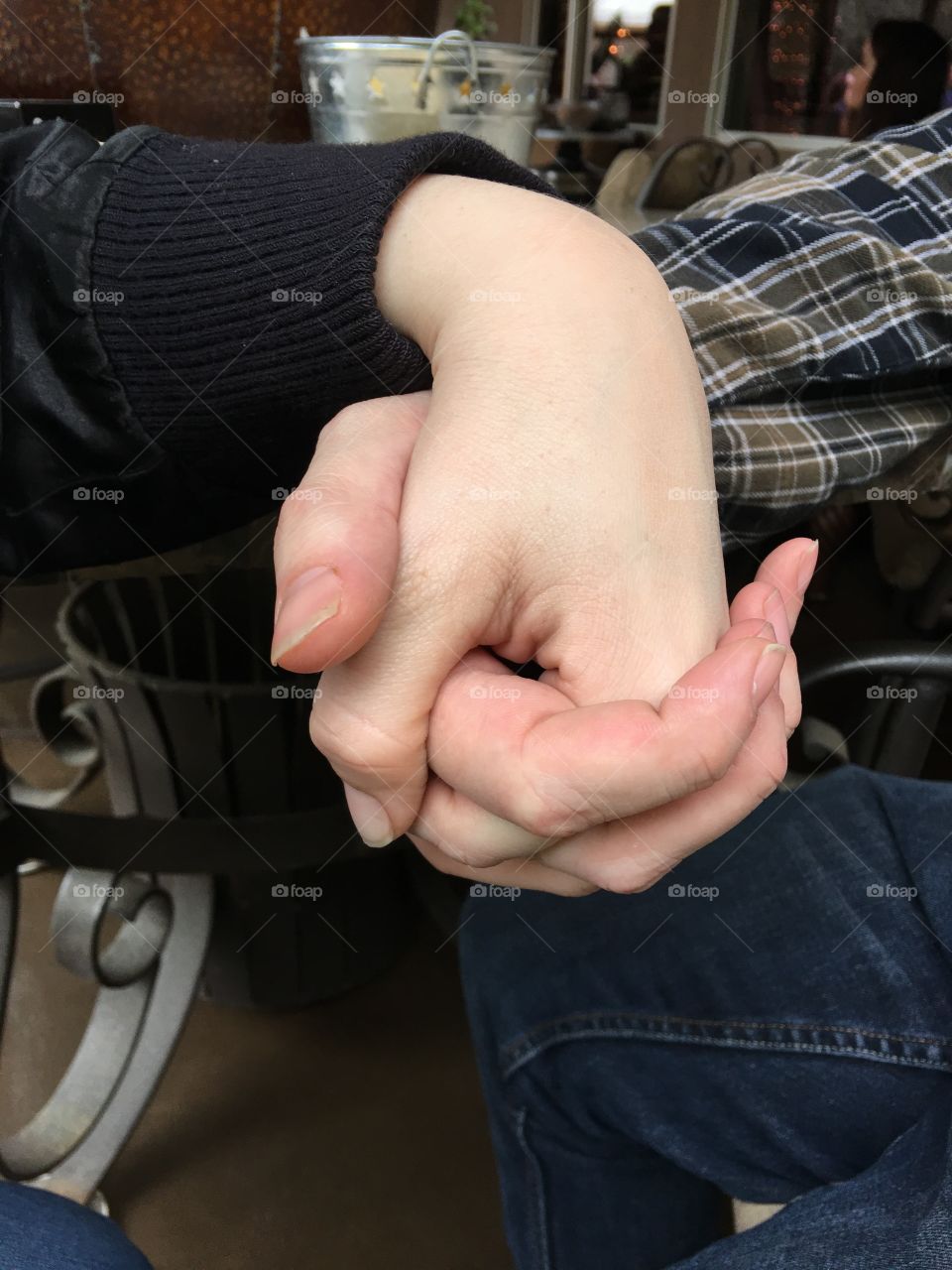 Close-up of two people holding hands