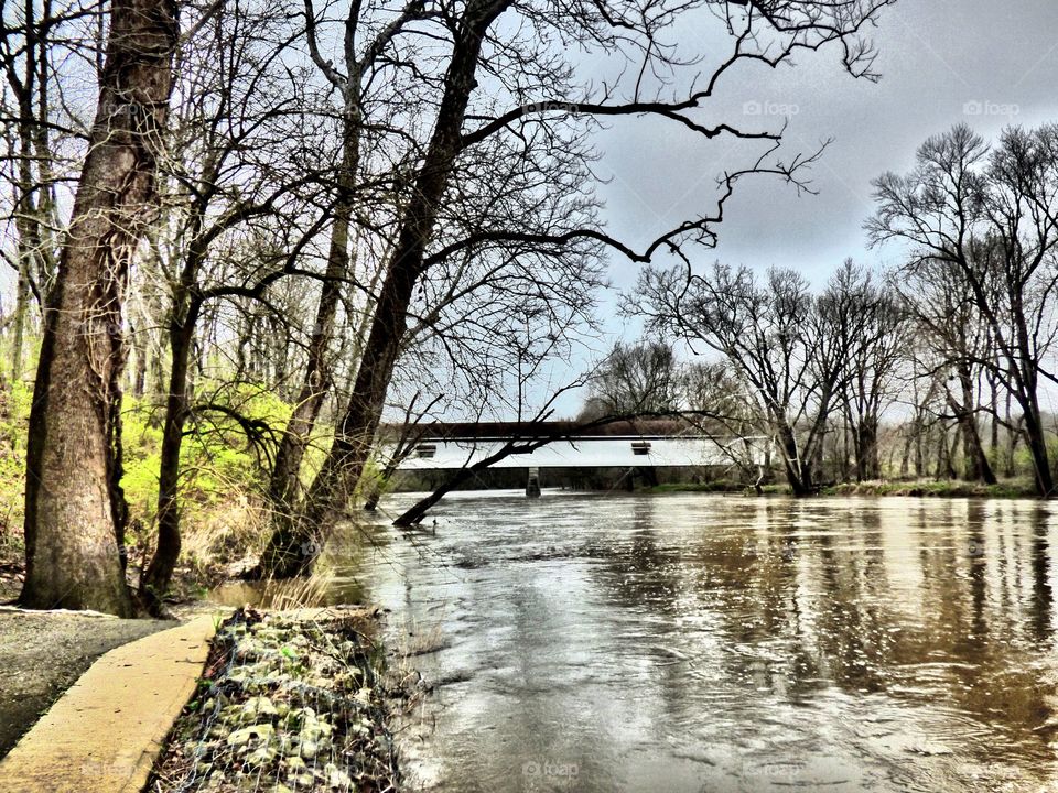 Covered bridge by the white river. 