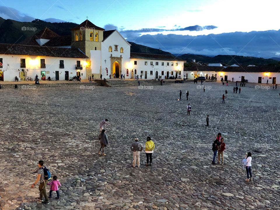 A quiet evening on the square, as people amble and children play in Villa de Leyva, Colombia 