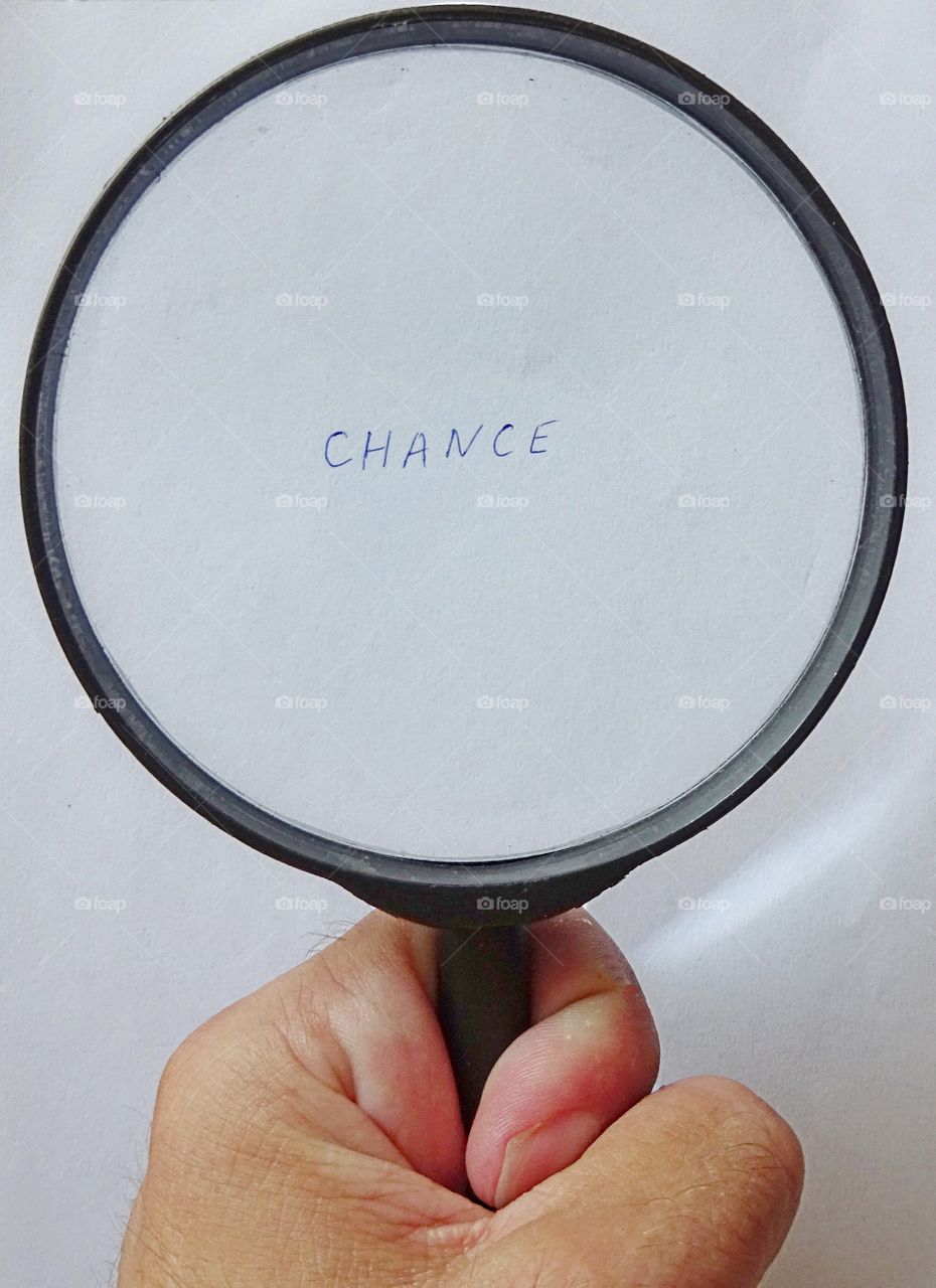 Magnifying glass and word chance on white background