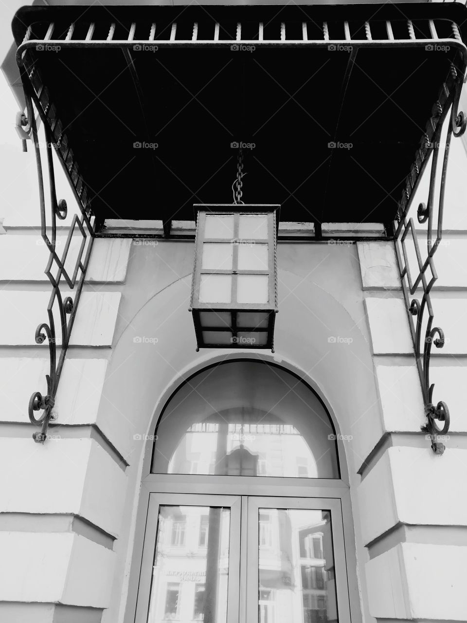 Shaped lantern under a metal canopy.