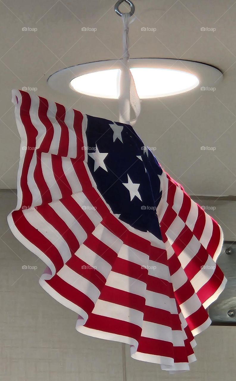 red, white, and blue ruffled patriotic American flag inspired hanging decoration in a fast food restaurant to celebrate Independence Day