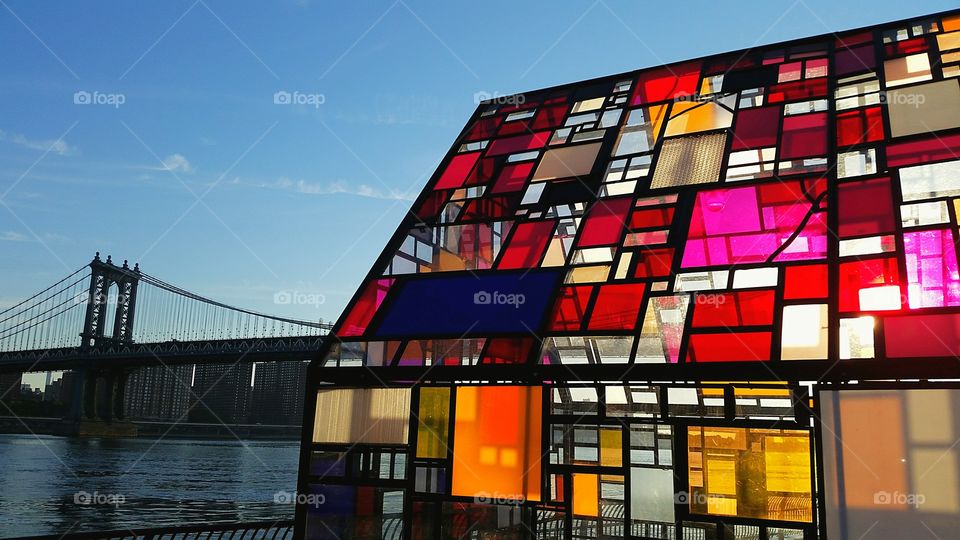 stained glass building with the Brooklyn​ bridge in the background