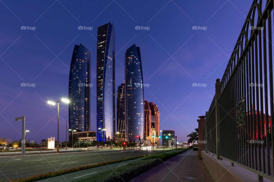 High rise modern buildings in Abu Dhabi at sunset. Urban environment.