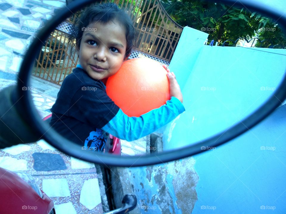 Girl reflected in the mirror on bike