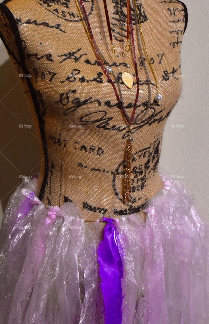 Mannequin at fine art center with a purple ribbon